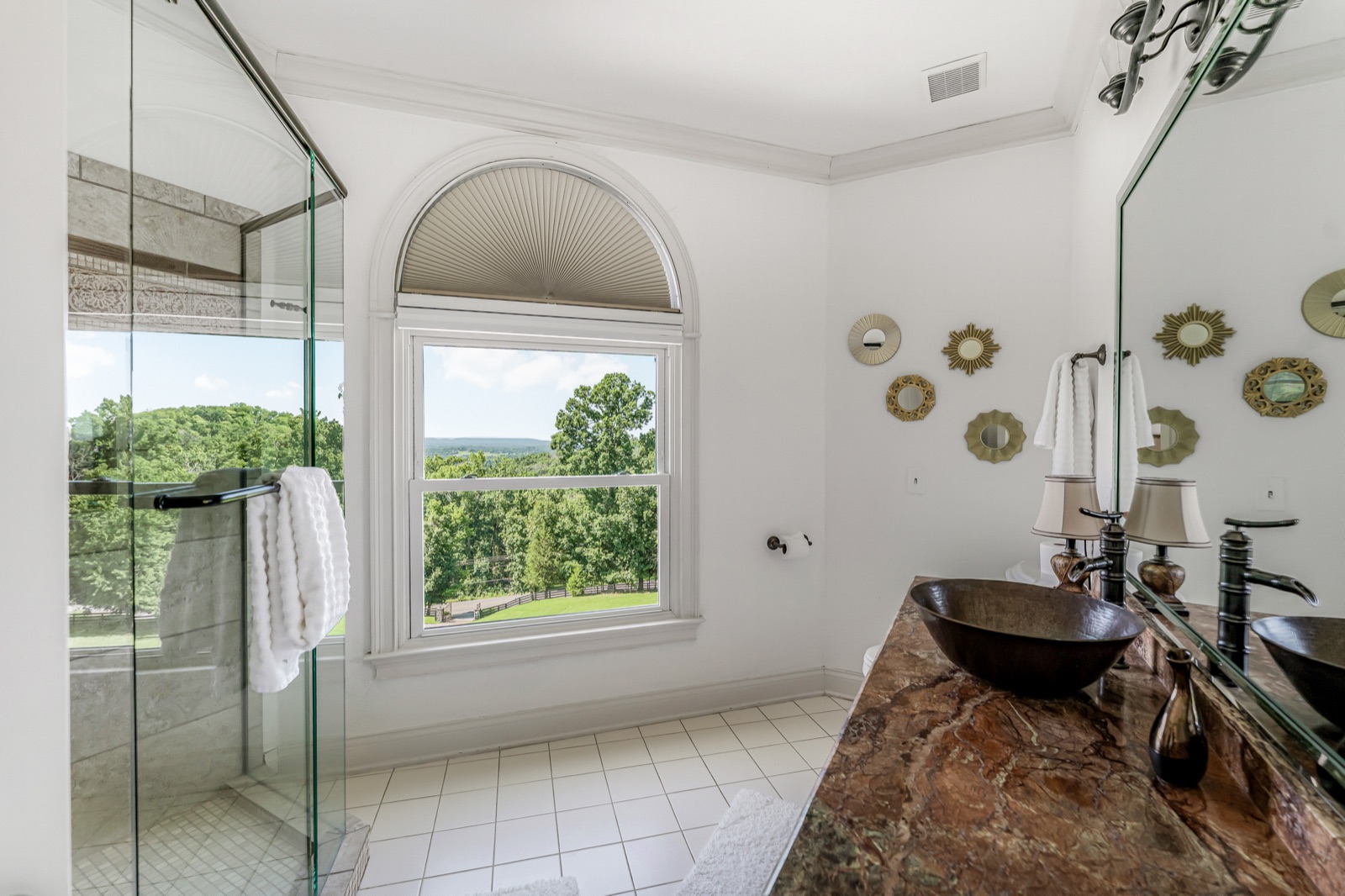 Double vessels on stone, the shower in glass