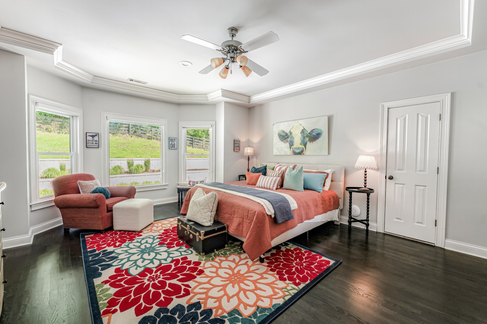 Bedroom two: a bay of windows over the lawn, reading chair beside the bed.