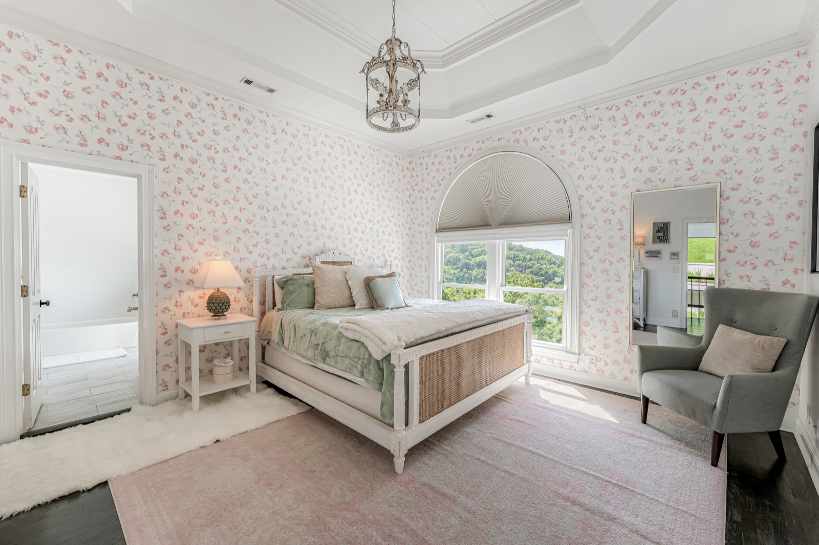 Bedroom four: rose wallpaper and an arched window over the valley.