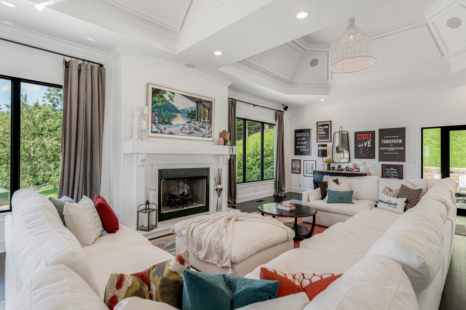The lower level's main living room, with its own fireplace and doors out to the grounds.