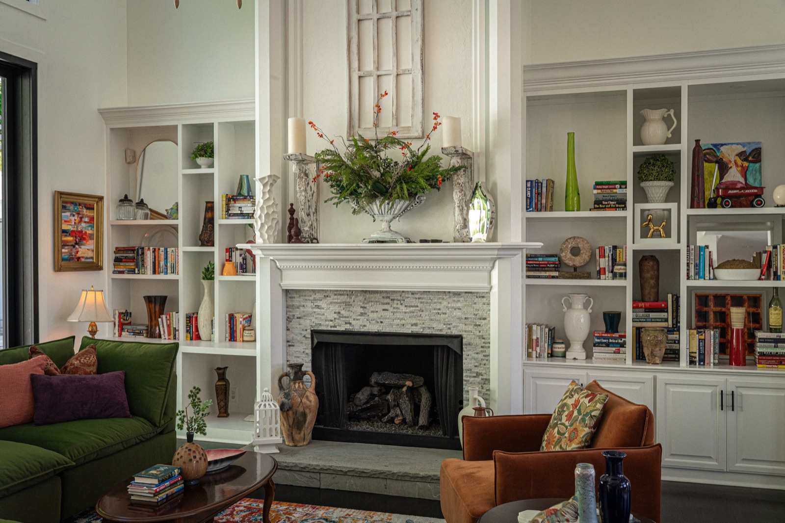 A fireplace ringed floor-to-ceiling by built-ins