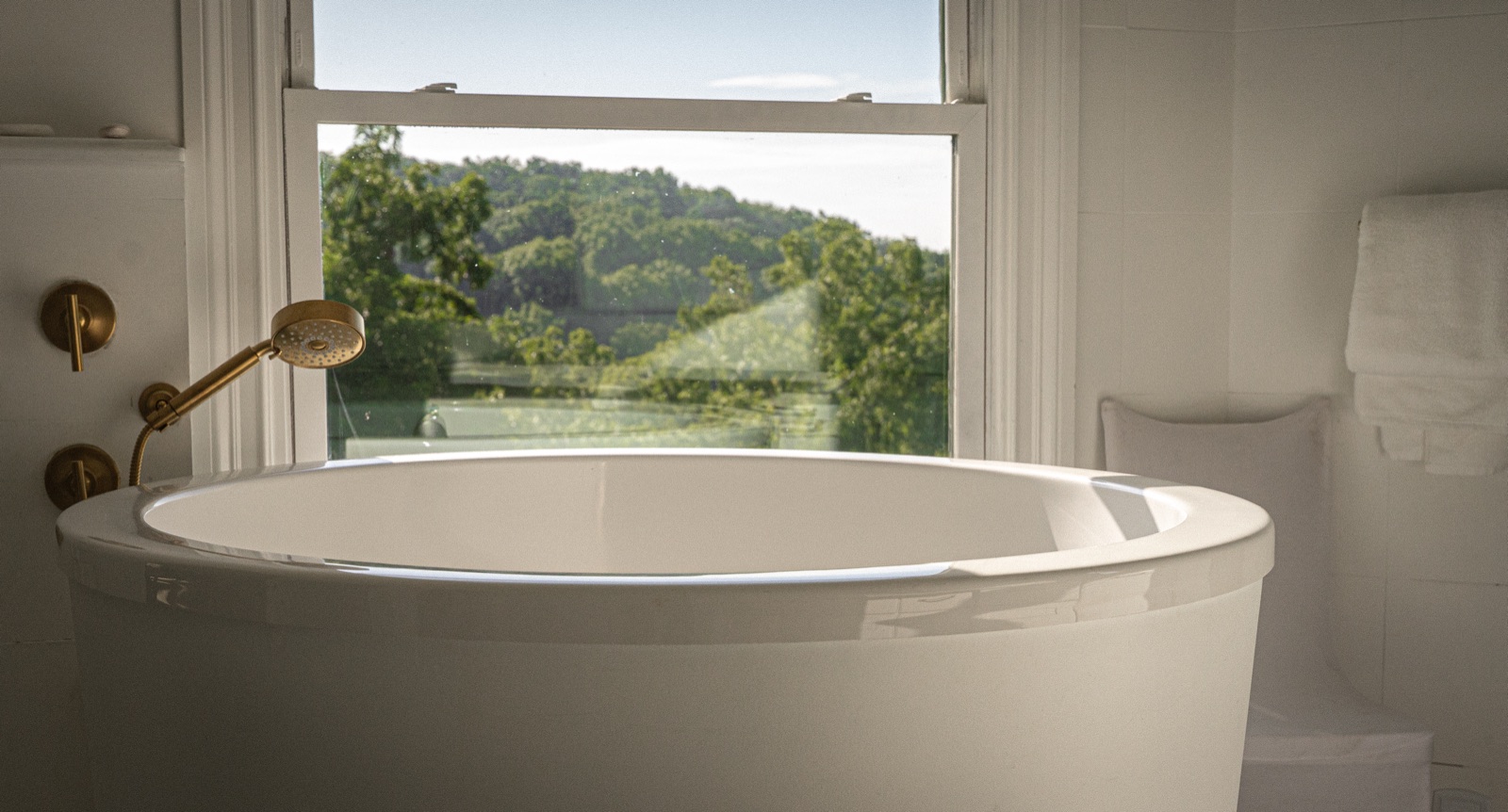 The owner's-suite soaking tub, positioned to the window and the county view beyond.