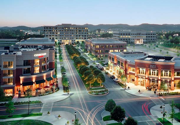 Cool Springs at dusk: the town center's shops, offices, and tree-lined boulevard from above.