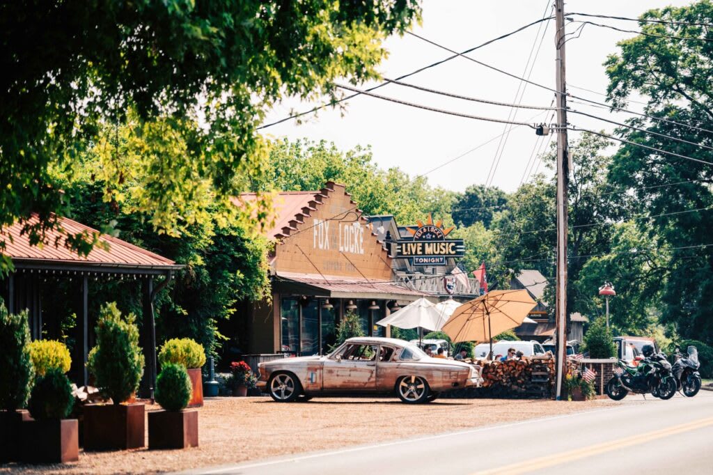 Leiper's Fork: the porch at Fox & Locke, a vintage coupe parked out front, live music tonight.